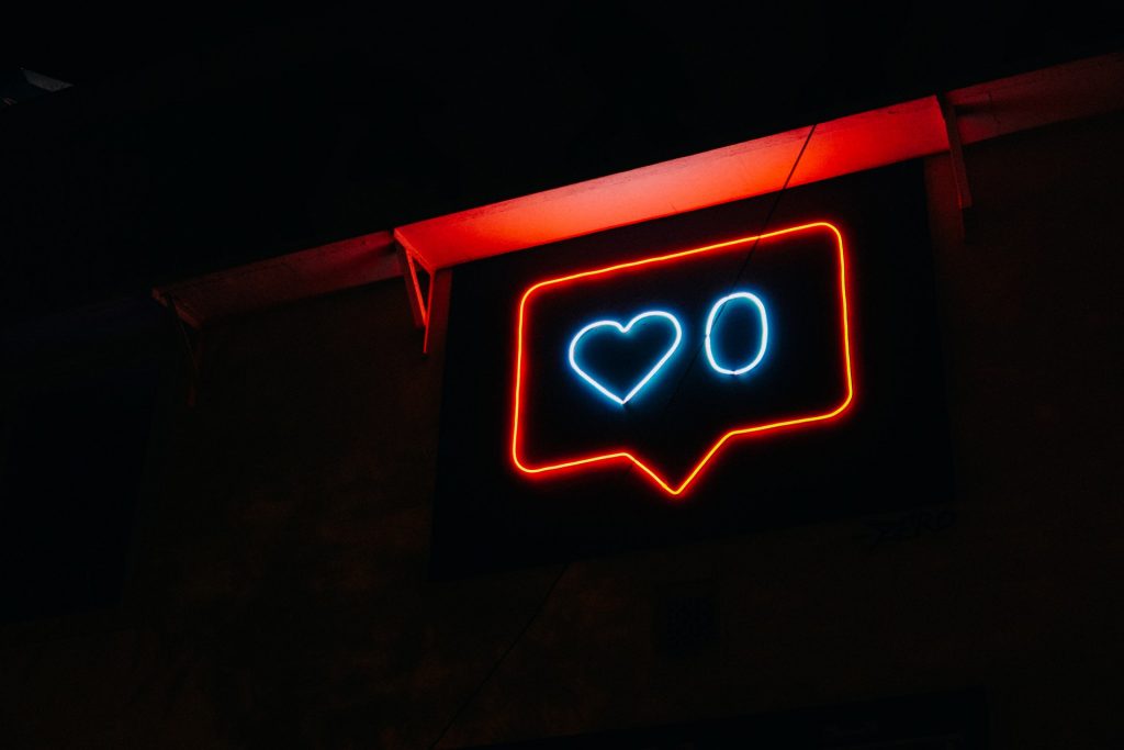 un letrero de neón con un corazón y un círculo azul