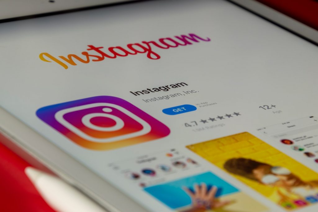 Instagram icon and application from app store on iPhone display screen.