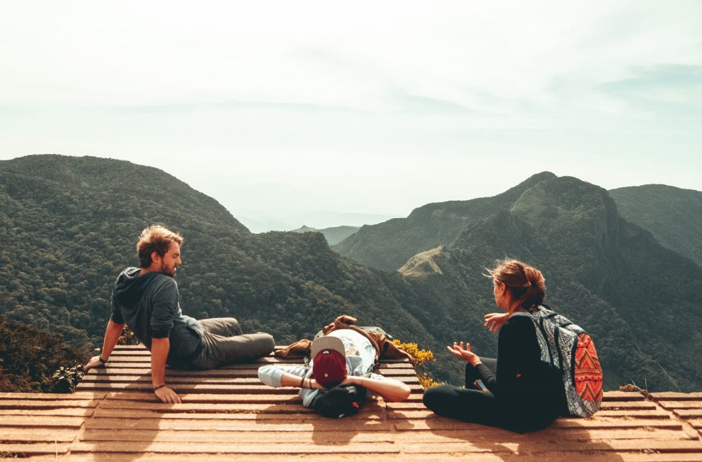 Three Instagram influencers taking a picture with mountains in the background.