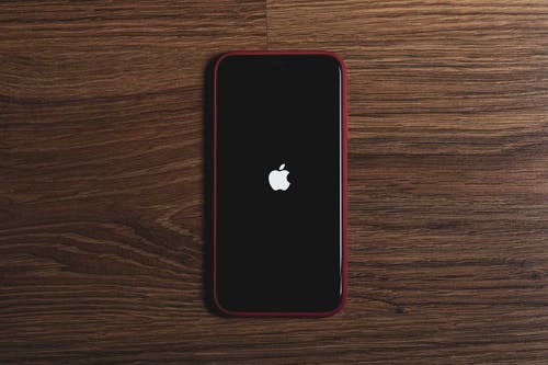 Black phone with the apple icon on a black screen