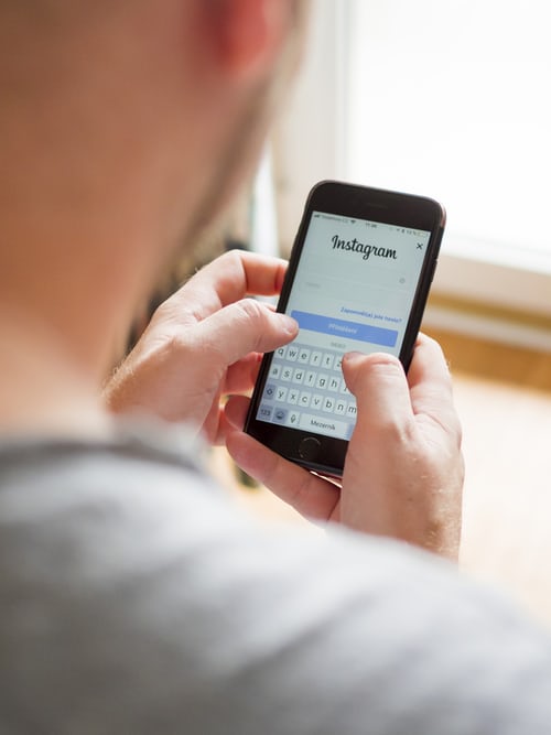 Person typing on phone to add link to Instagram story
