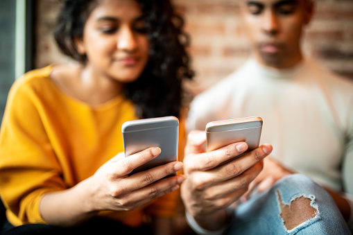 A man and a woman on their phones.