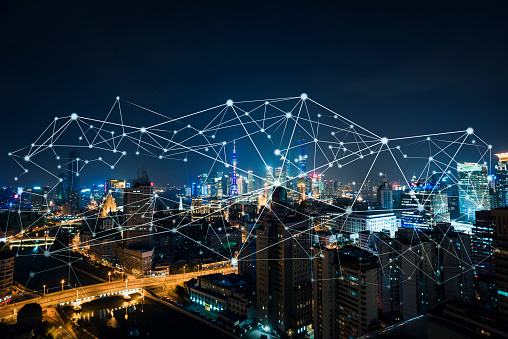 Cityscape at night showing a web of virtual connections to demonstrate high user activity levels and the best times to post on Instagram.