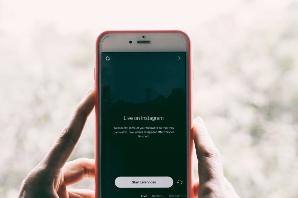 Person starting Live feed on Instagram to reach more people and get more Instagram followers.