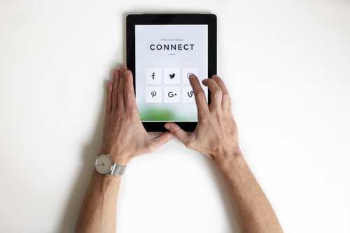 Tablet screen showing various social media platforms to demonstrate linking of accounts to find potential Instagram followers.