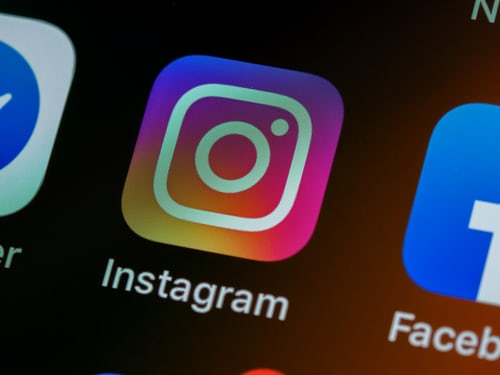 Close-up shot of a phone screen showing Instagram app icon.