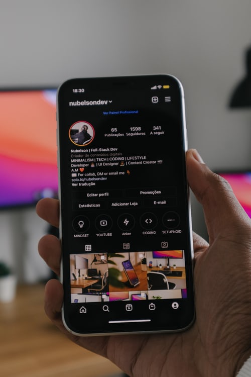 Black phone showing Instagram profile and Instagram album photos.
