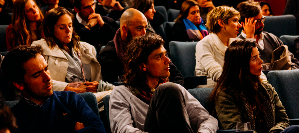 Audience members deeply engaged and attentive during a captivating event or presentation.