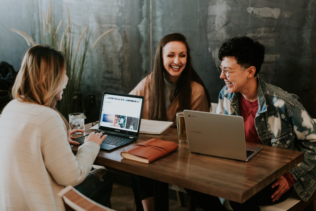 A group of people working on their laptops to promote an Instagram brand. 