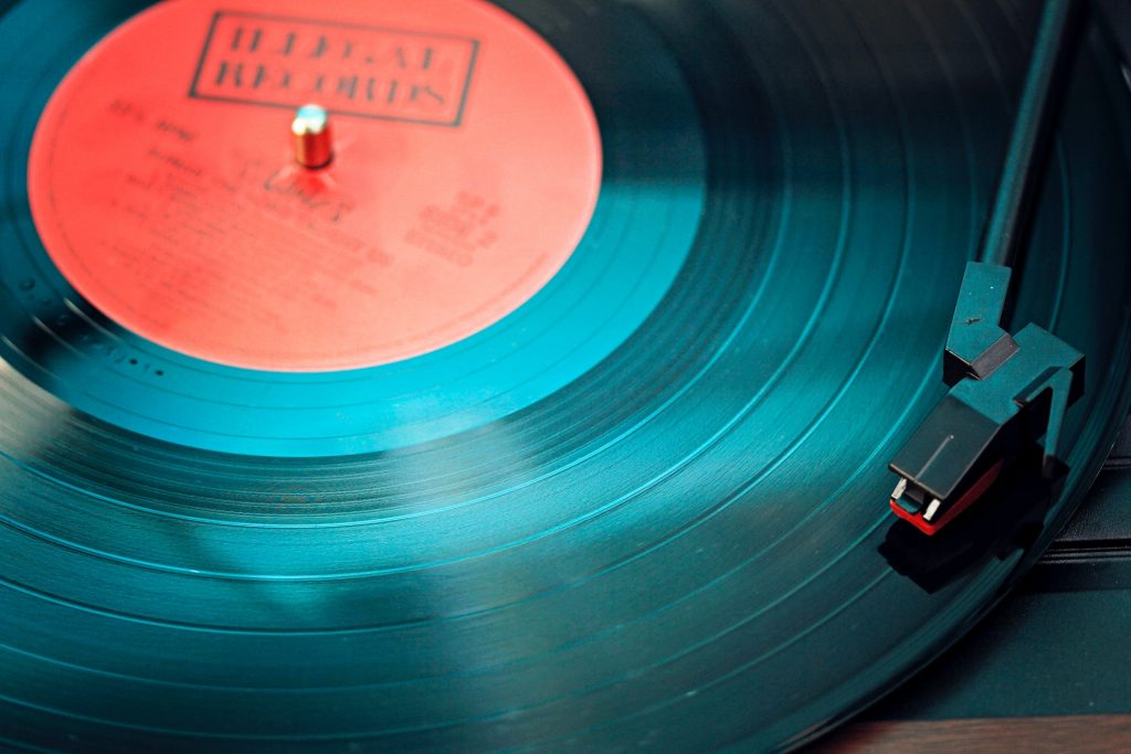 Vinyl record on a turntable playing music that are good for Instagram.