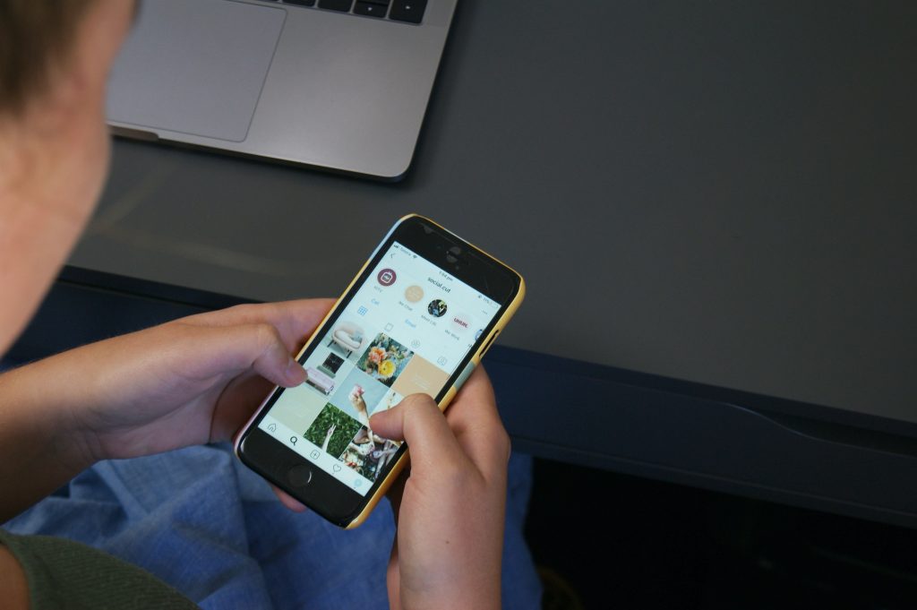 s-o-c-i-a-l-c-u-t-hCjo_bIkVig-unsplash-1 | Path Social Person on his phone trying to reach out to his preferred brand partners on Instagram.