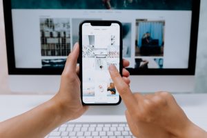 Person using a smart phone and asking can you see who viewed your Instagram videos?