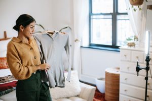 Person sharing content with followers, learning how to become a fashion influencer.