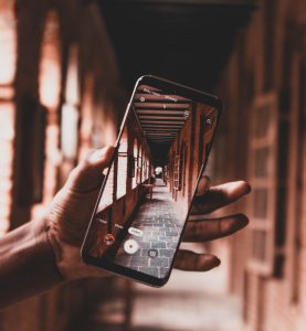 Person recording a video with a smartphone.