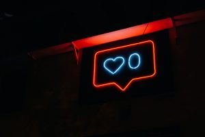 Instagram notification displayed with a neon light sign.