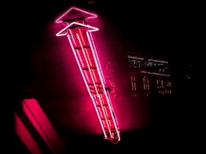 Red neon arrow pointing up to represent follower growth from MrInsta.
