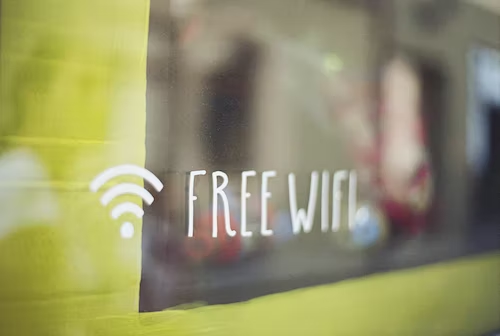 Free WiFi sign painted on a storefront to invite customers and potential new followers.