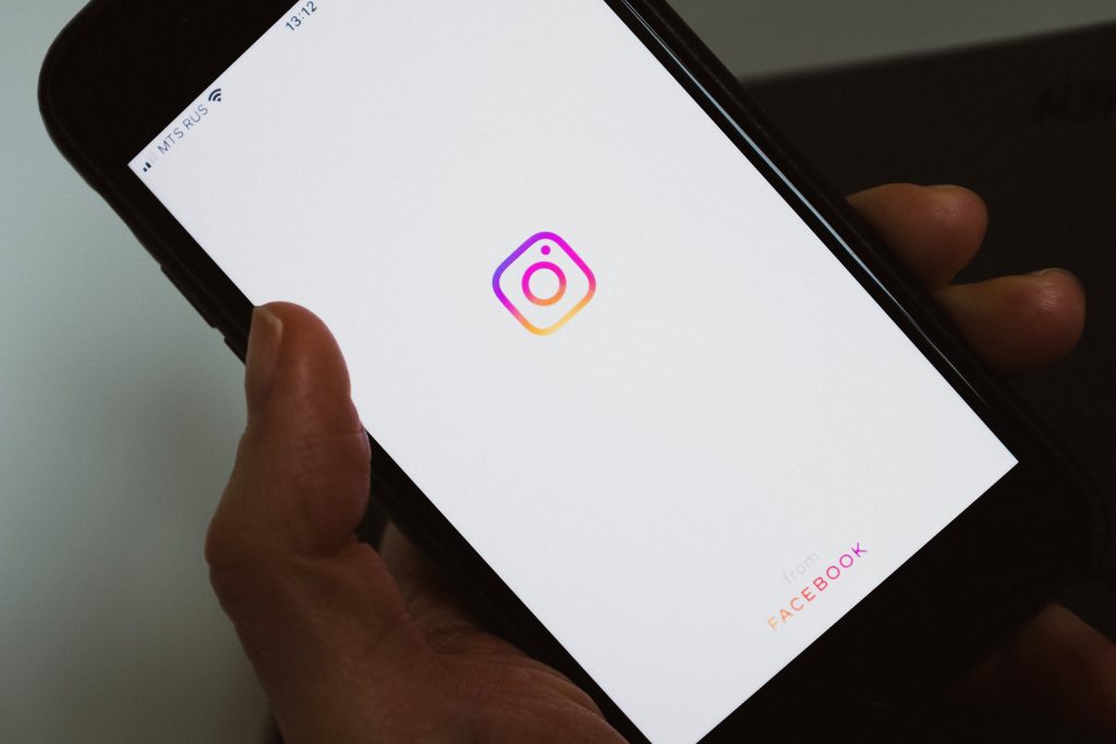 Smartphone highlighted to show Instagram app logo.