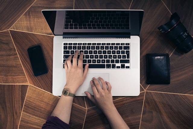 Person typing Instagram captions on a laptop.