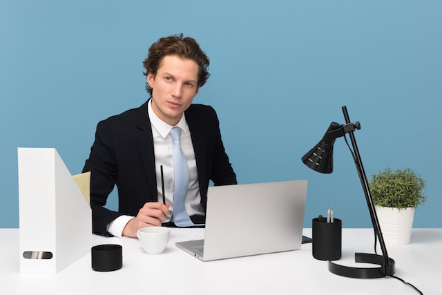 Young professional sitting in front of a laptop and performing Instagram management tasks.