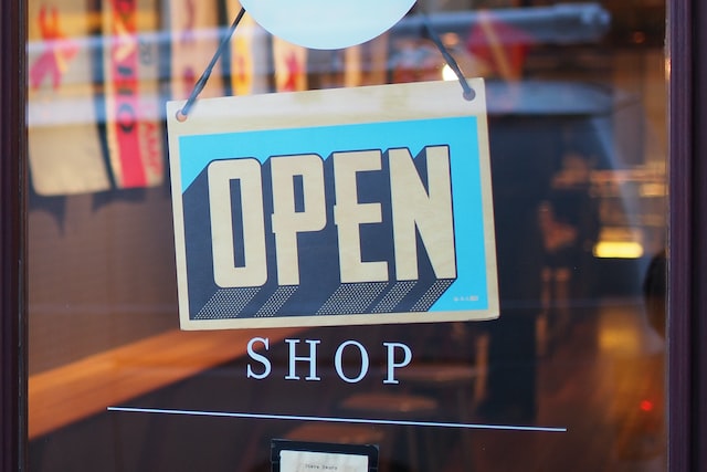 A store sign saying Open