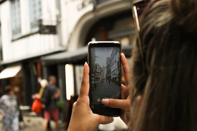 Person taking a photo with their phone for an Instagram story. 