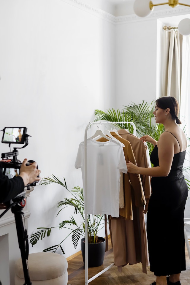 Women learning how to become a fashion influencer by sharing clothing with followers.