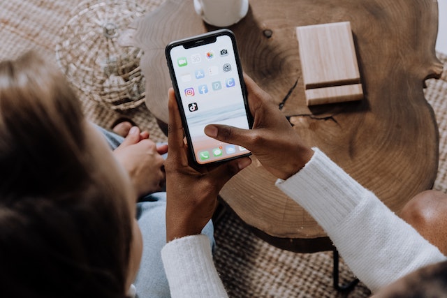 A person teaching a friend how to download Instagram stories.