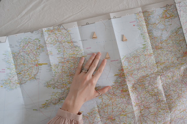 Women searching a map, looking for locations to learn how to become a travel influencer.