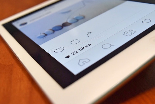  iPad open to the Instagram account, highlighting photo likes.