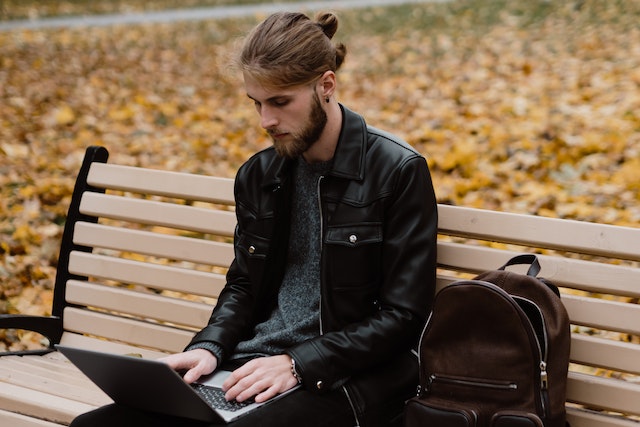 A nano influencer looking through his latest photo content on his computer.