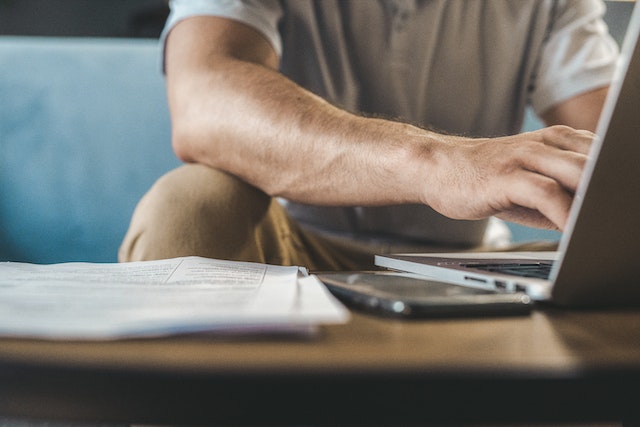 Man using a computer to research Instagram growth agency options.