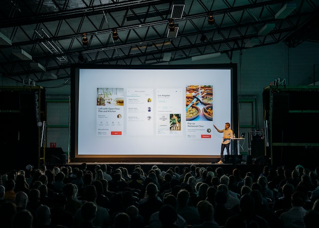 A man presenting at a conference for Instagram entrepreneurs