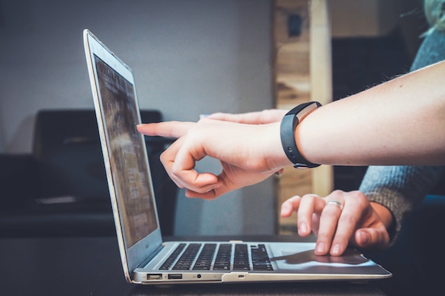 Two people looking at Instagram performance results on a laptop. 