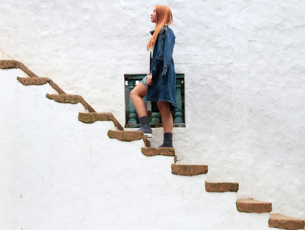 Woman climbing up concrete stairs. 