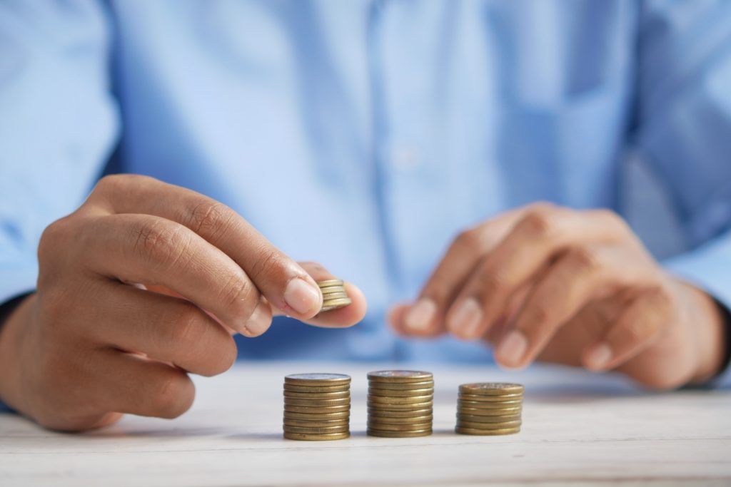 Person stacking coins.