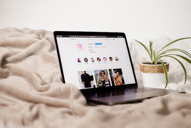 Laptop on blanket with Instagram feed on how to get more likes.