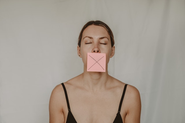 pexelsanetelusina5723266 | Path Social A person with a post it covering her mouth