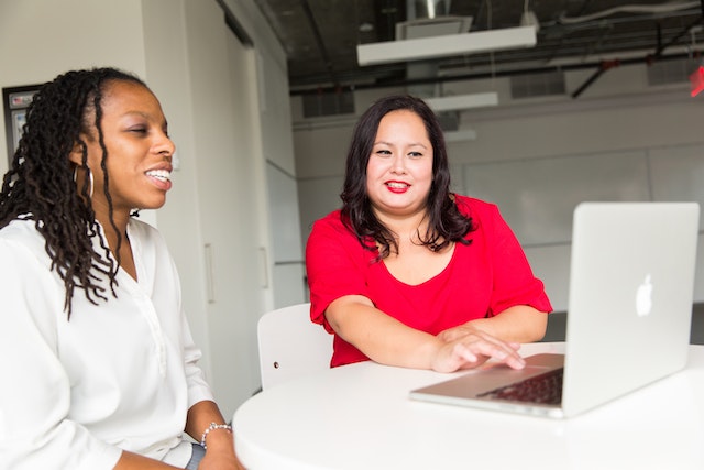 Two people researching what is the safest way to buy Instagram followers.