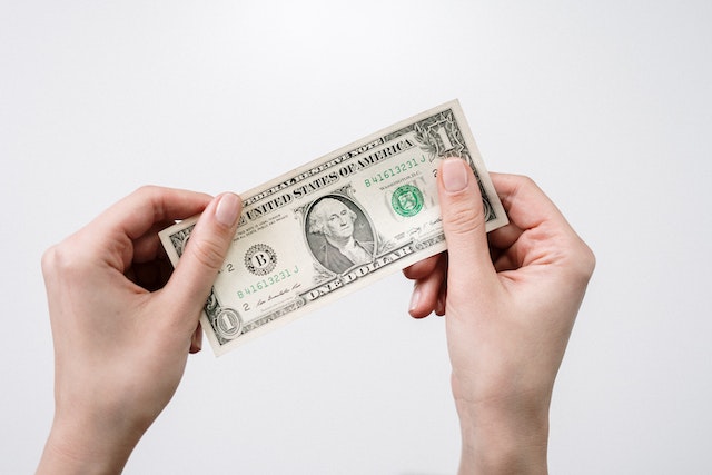 pexels-cottonbro-studio-3943748 | Path Social Hand holding one dollar bill.
