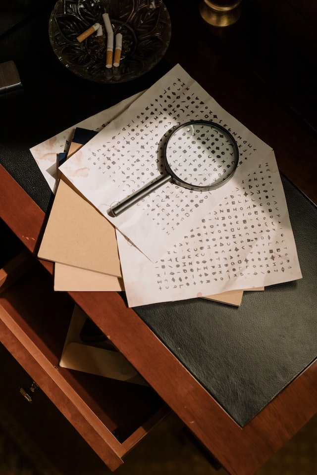 Magnifying glass on a stack of papers