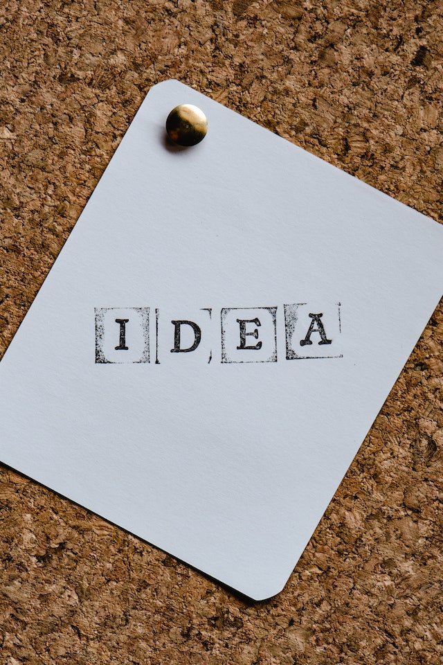 IDEA stamped in block capitals on white paper and pinned