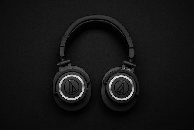 Large headphones against a black background.