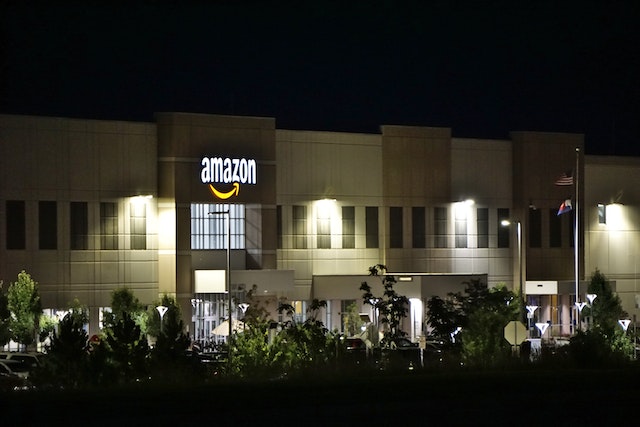 Concrete amazon building with the words lit up.
