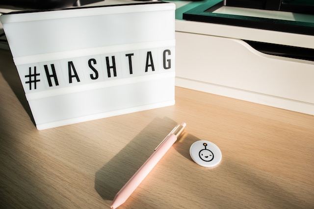 A pen on a desk with a text box that says #hashtag.