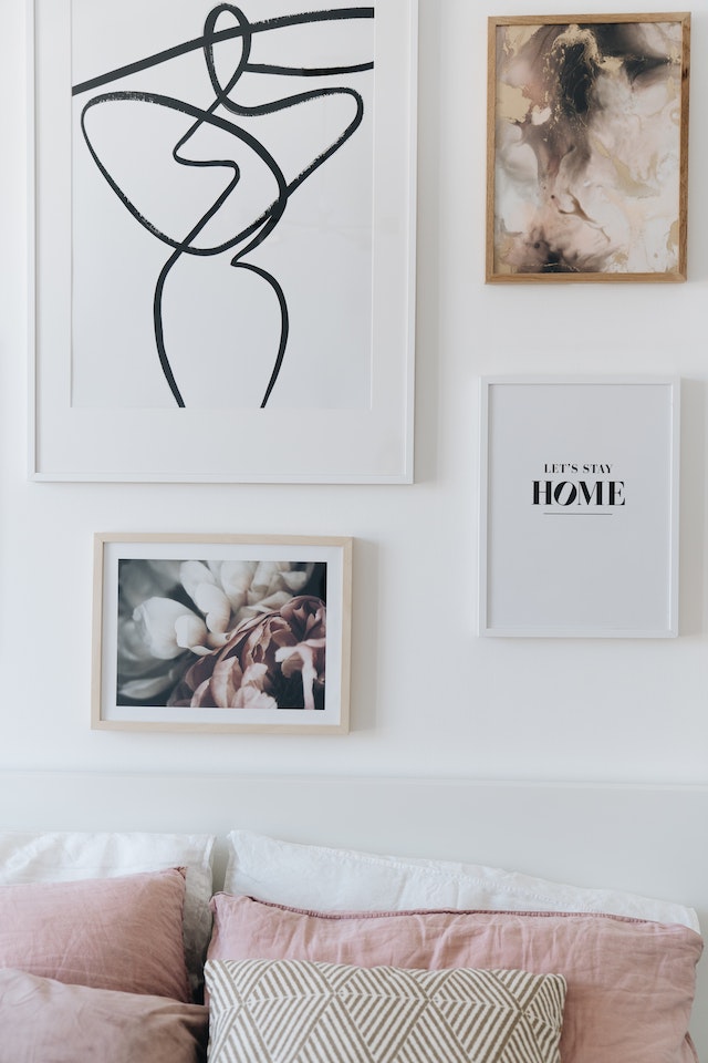 Wooden Framed Pictures Hanging on the White Wall
