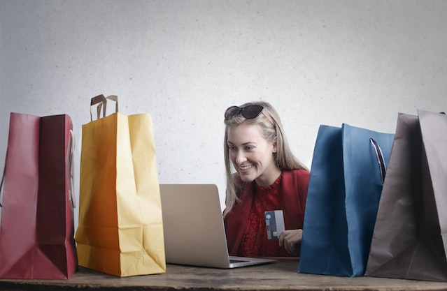 A woman happily purchasing products from an Instagram Shop.