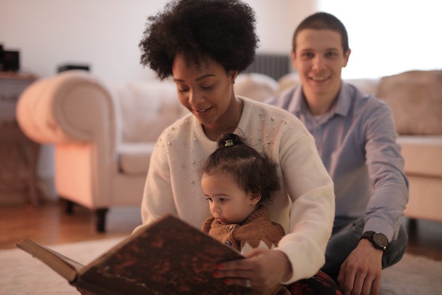 Photo of woman reading a story to her child.