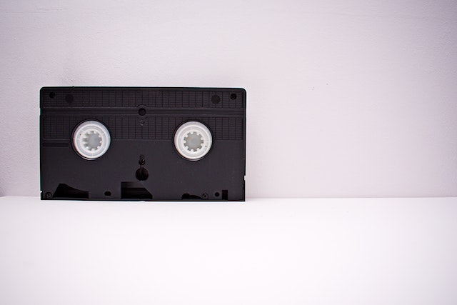 Black And White Vhs Tape On 
White Wooden Surface
