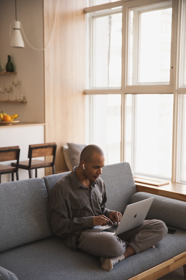 pexels-ekaterina-bolovtsova-4049454 | Path Social Man on the couch using his laptop.